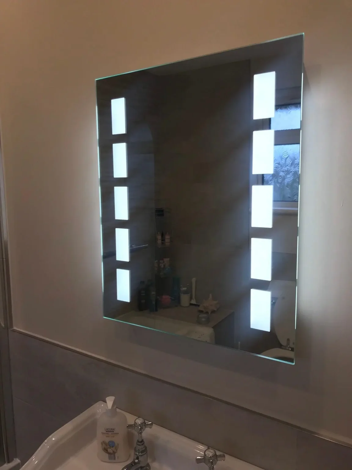 led bathroom mirror electrical services - L & W Electrical Ltd Modern bathroom mirror with built-in LED lighting installed by L&W Electrical Ltd, expert Electrical Services in Swansea.